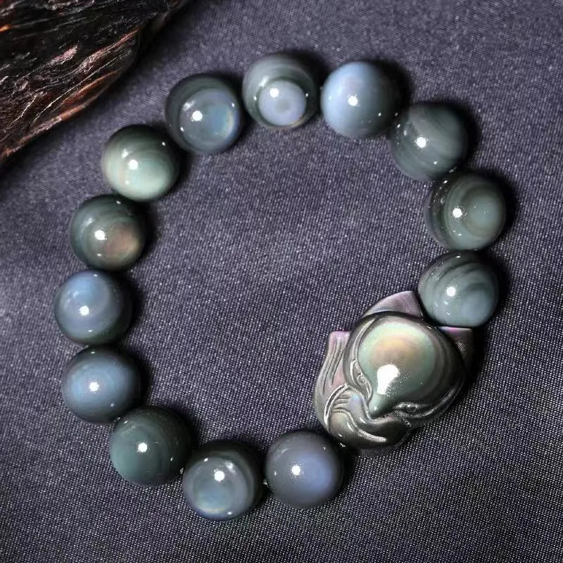 Obsidian stone bracelet with carved fox design in cartoon style, shown in various sizes