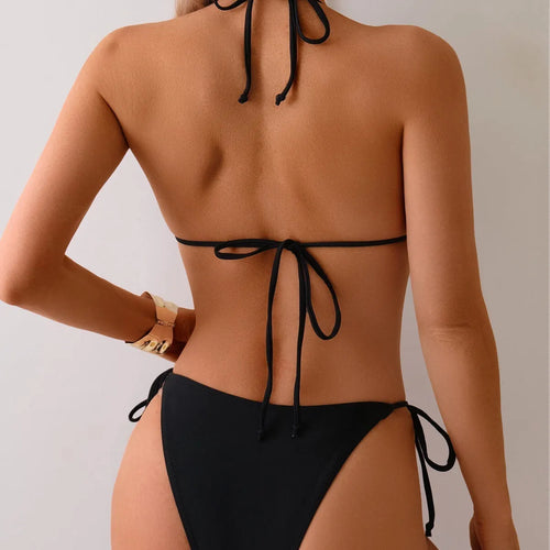 Black women's bikini swimsuit with metal bead detail and split design