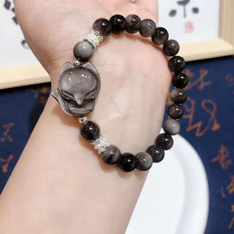 Natural silver stone big head fox bracelet with 8mm obsidian beads on a white background