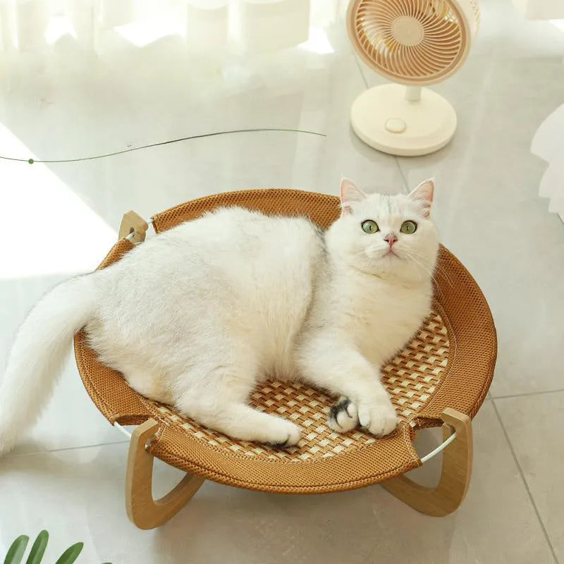 Brown woven rattan off-ground hammock bed for cats and small dogs.