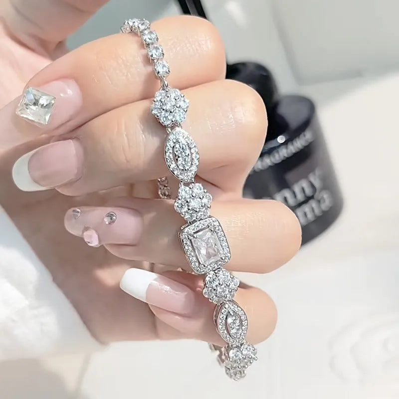 Women's geometric zircon bracelet with silver and white gold plating showing chain length options