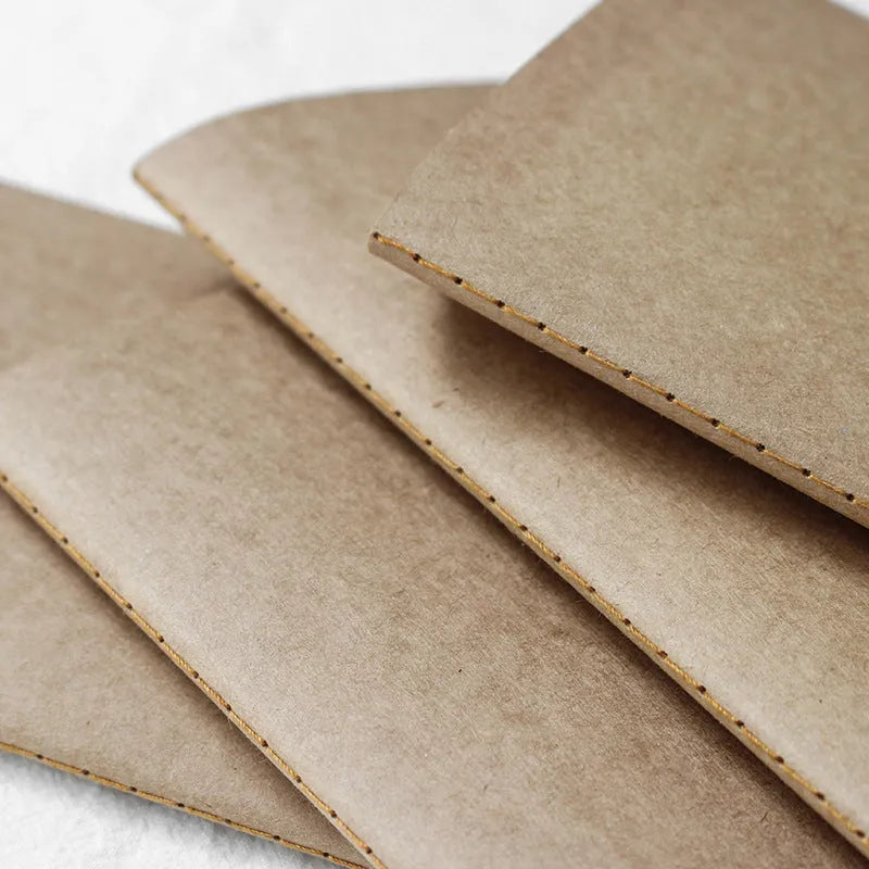 Cowhide diary refill inner core showing saddle stitch binding and 100g ivory white paper