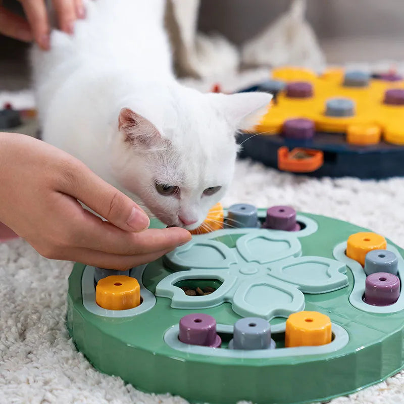 Blue interactive dog slow feeder puzzle toy with multiple food compartments on textured base