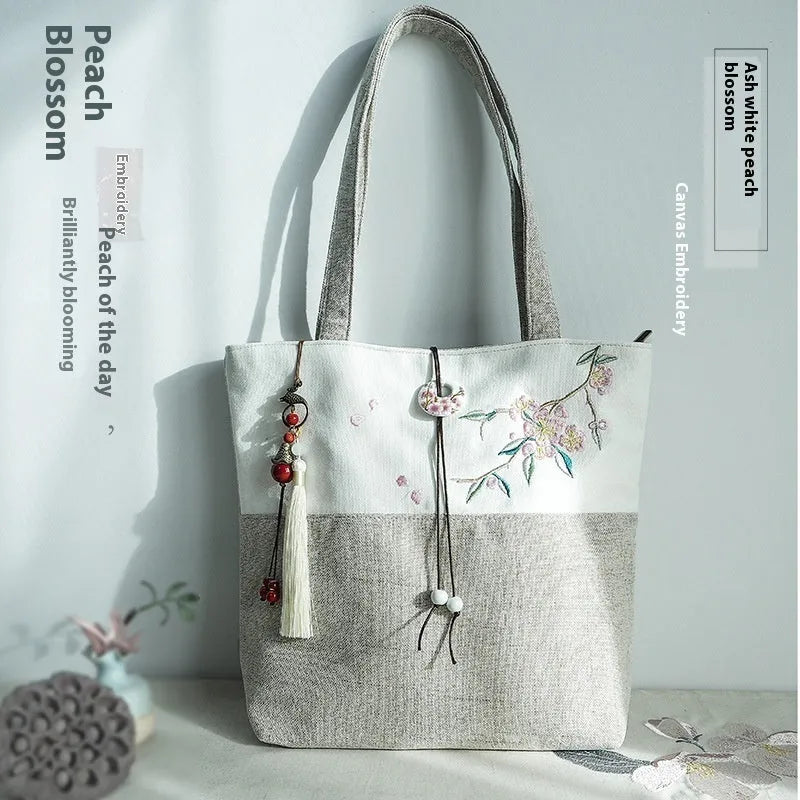 Artistic retro canvas shoulder handbag with hand-painted literary design and copper zipper
