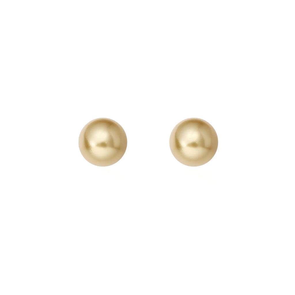 A pair of large pearl stud earrings with a geometric silver setting and an eight-point star detail.