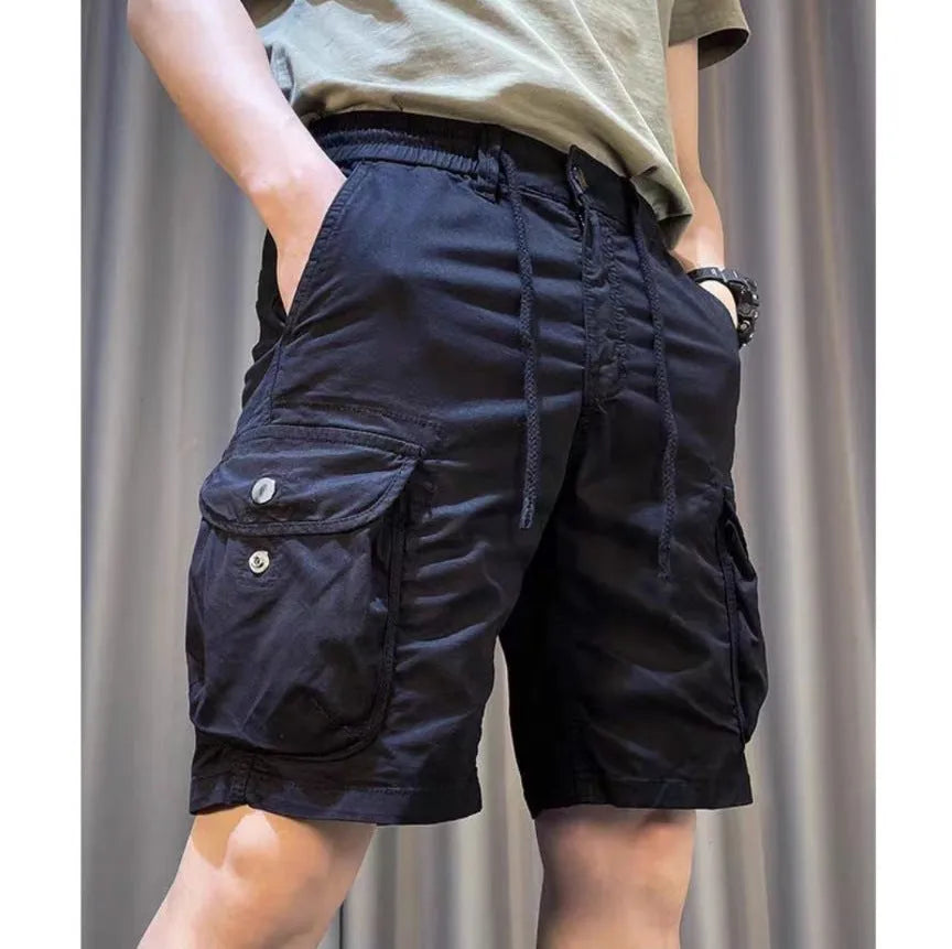 Loose straight-leg multi-pocket casual overalls trousers in khaki colour on a hanger.