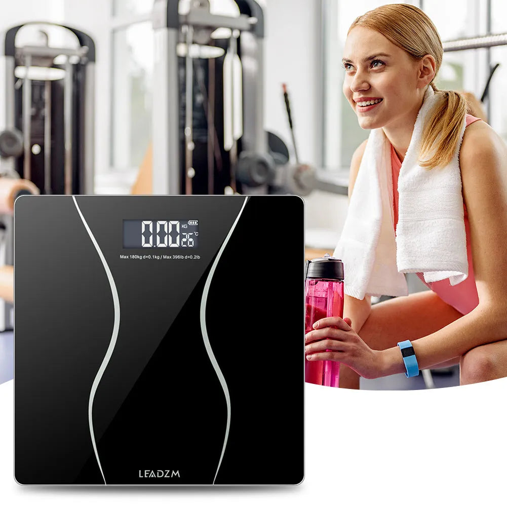 Black electronic bathroom scale with digital display for weight measurement up to 180 kg.