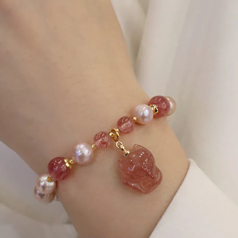 Light pink freshwater pearl bracelet for women with a dangling silver fox charm.