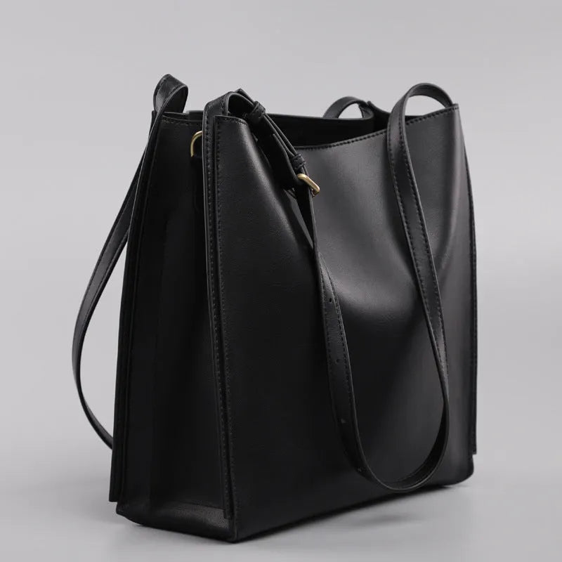 Brown genuine leather women's retro bucket bag with double shoulder straps showing interior organisation compartments