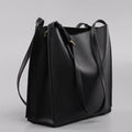 Brown genuine leather women's retro bucket bag with double shoulder straps showing interior organisation compartments