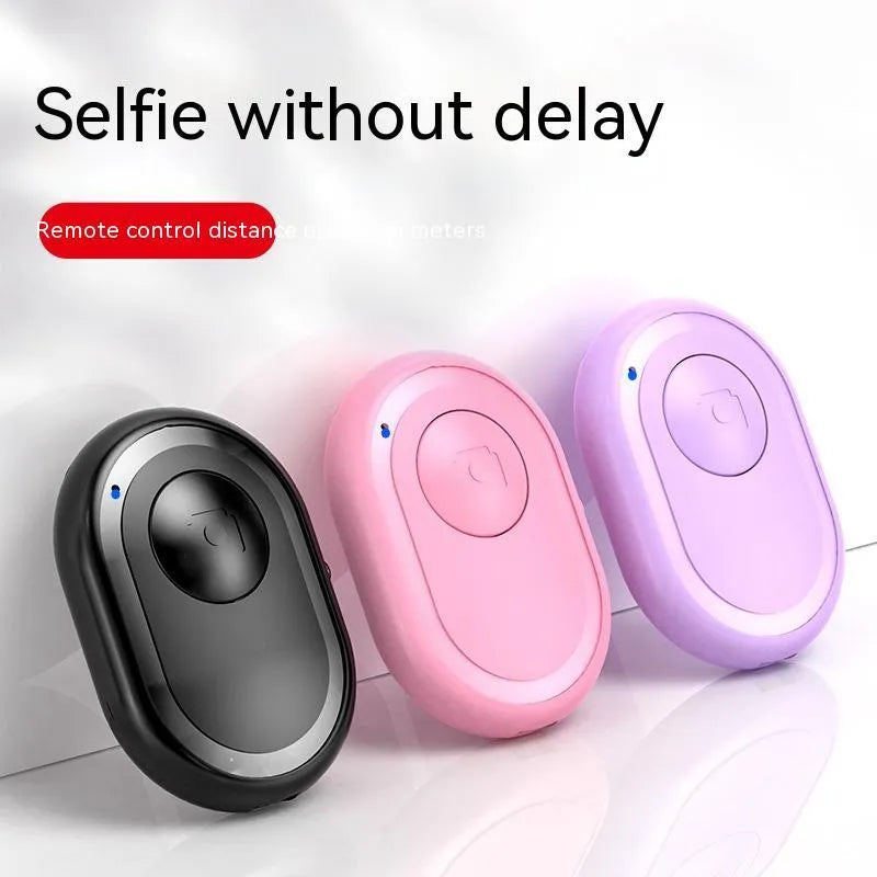 Wireless Bluetooth photo remote control in black, pink, or purple colours showing compact size