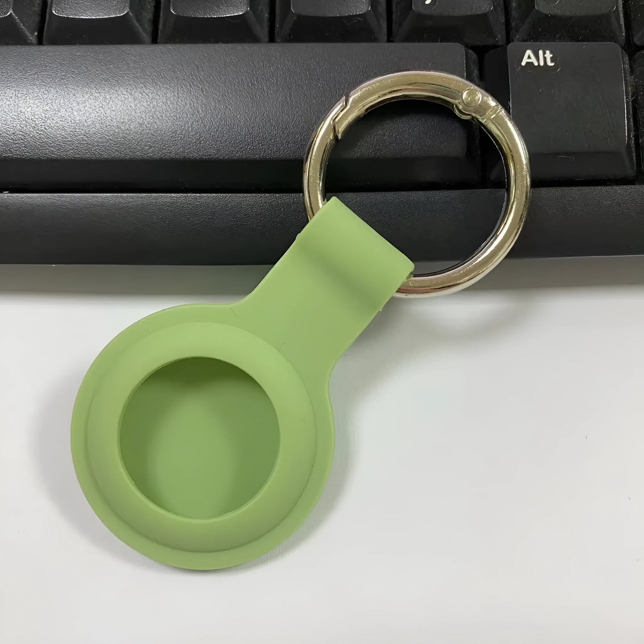 Silicone protective case with metal keychain snap for Apple AirTag in multiple colours.