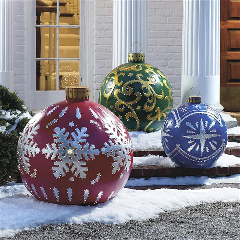 Large red and white striped inflatable Christmas ball ornament hanging on an outdoor tree