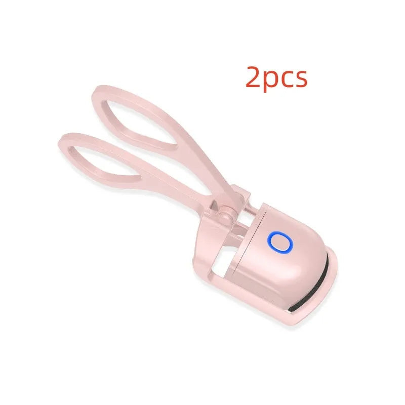 White and pink USB rechargeable heated eyelash curler with dual temperature settings.