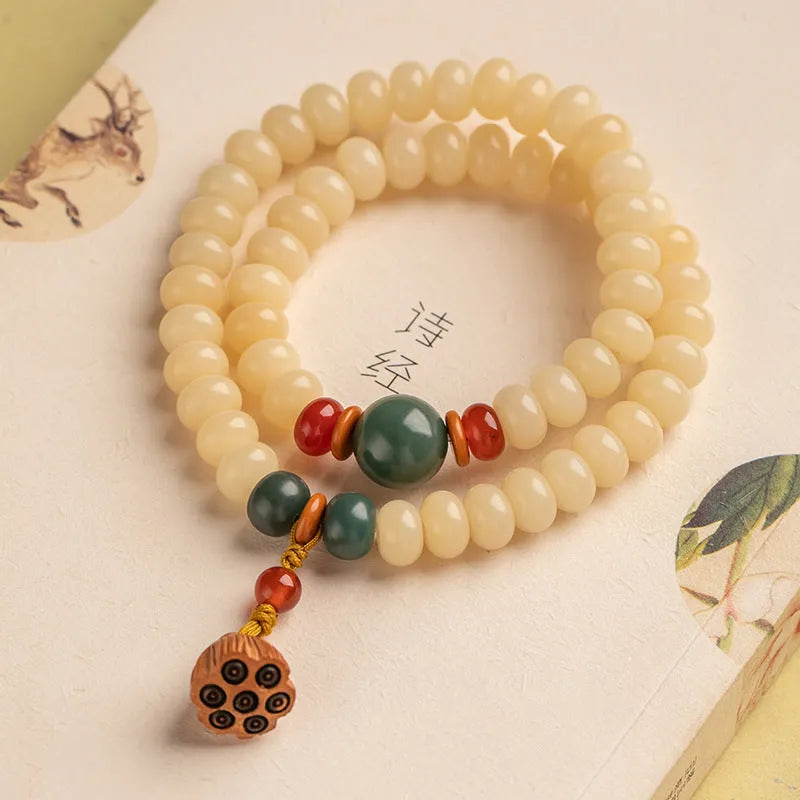 Milk butter coloured Bodhi root wood bracelet with 6x9mm flat round beads on wrist