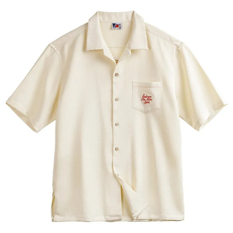 Light apricot men's Cuban collar shirt with bamboo and floral plant pattern.