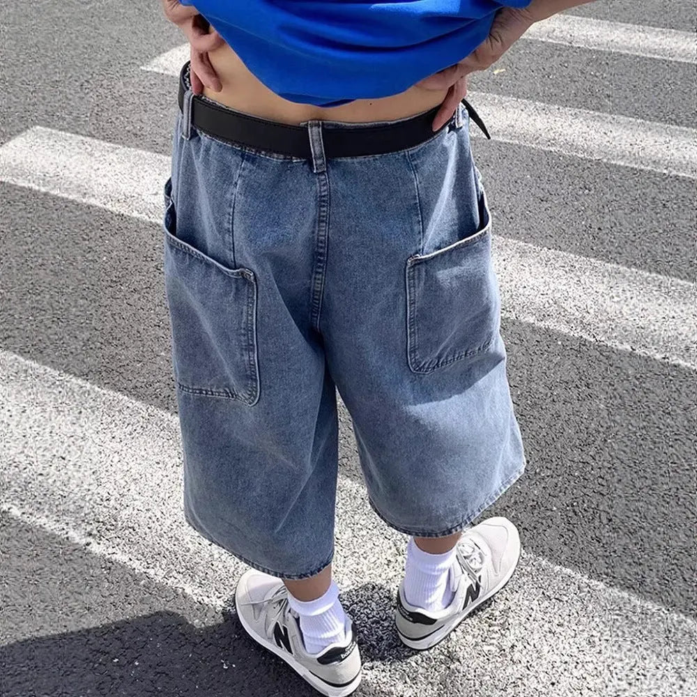 Blue washed denim pirate shorts for men with a high waist and straight leg, laid flat.