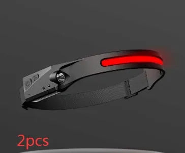 Black silicone USB rechargeable LED headlamp with side wave sensor, showing wide beam and long-range lighting.