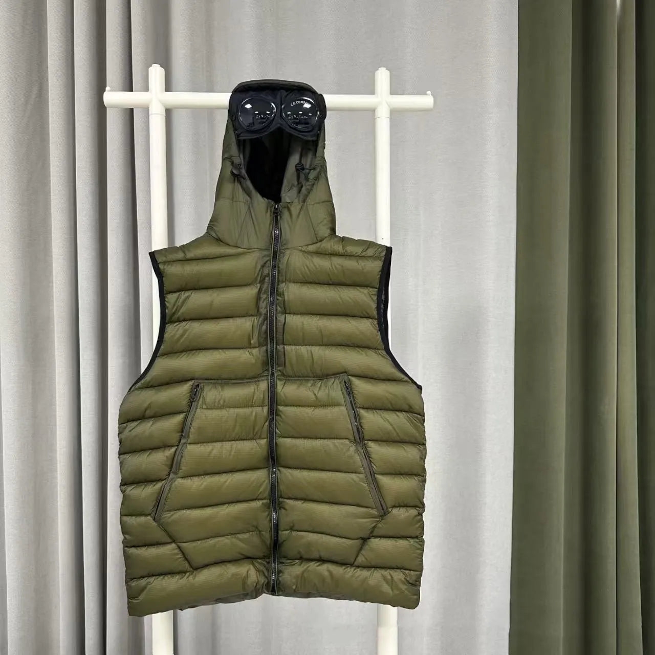 Men's loose hooded cotton vest jacket in black, side view, showing hood and zip closure