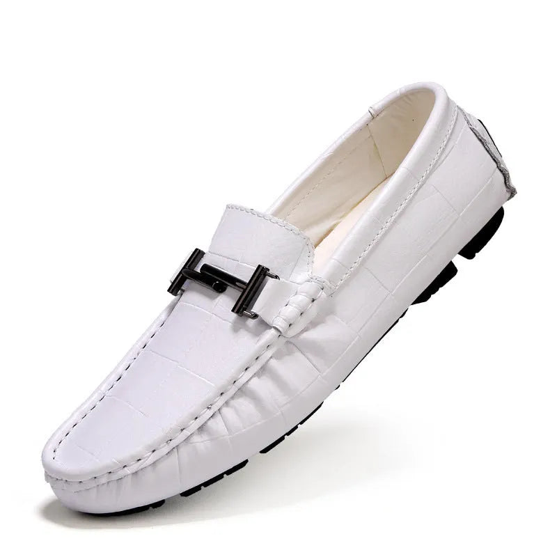 Men's black leather casual shoes with a silver belt buckle closure on a flat rubber sole.