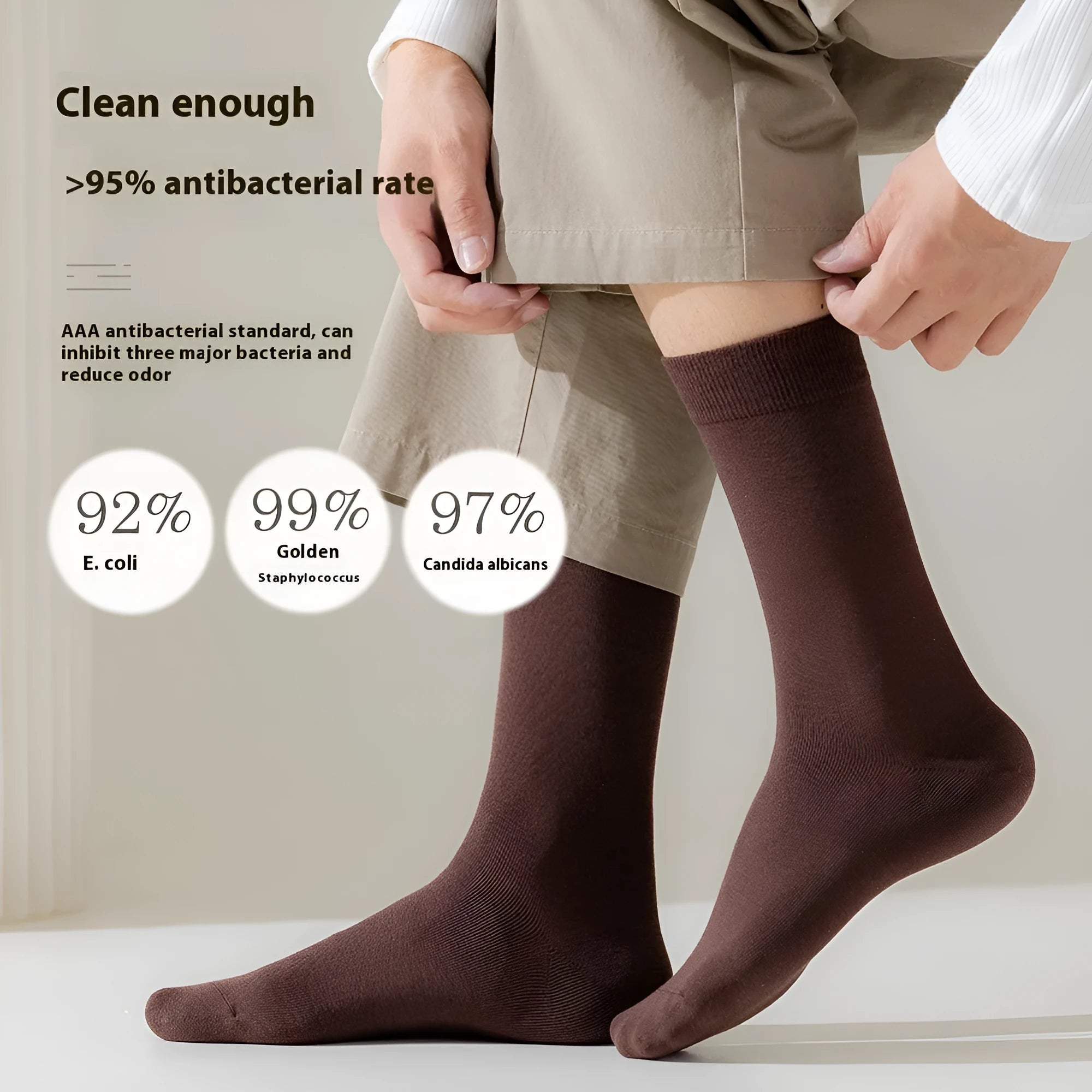 Five pairs of men's solid colour mid-calf socks made from combed cotton, shown in assorted shades.