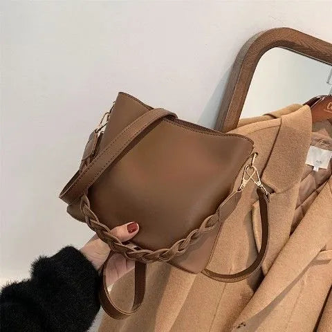 Retro woven PU leather bucket bag in khaki colour with crossbody strap.