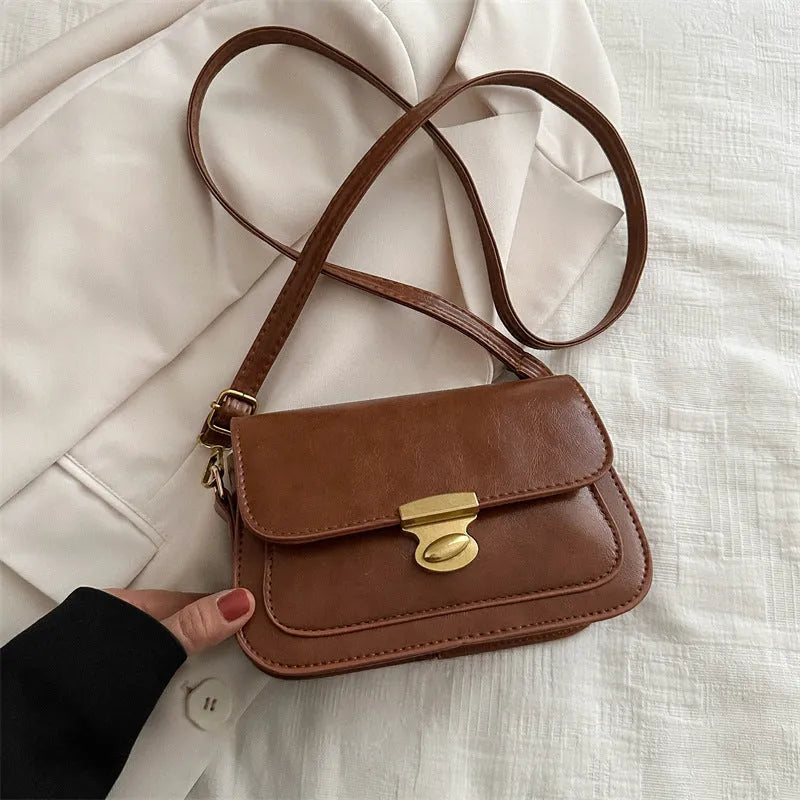 Small horizontal square handbag in soft PU leather, shown in black, brown, dark brown, and light brown.