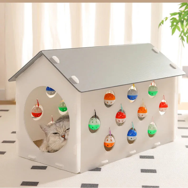 White plastic integrated cat scratch board with attached enclosed nest and curving tunnel toy for indoor cats.