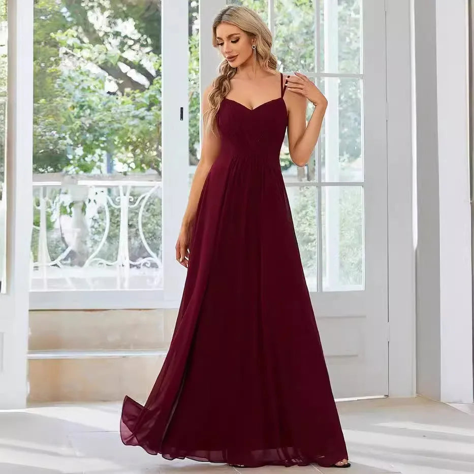Women's sleeveless banquet dress with pleated A-line long skirt in light green, showing sling neckline.