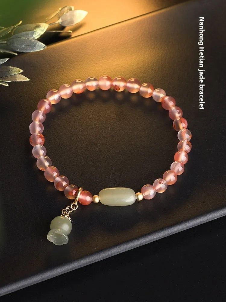 Nanhong agate bracelet with flower design and bamboo joint elements on wrist
