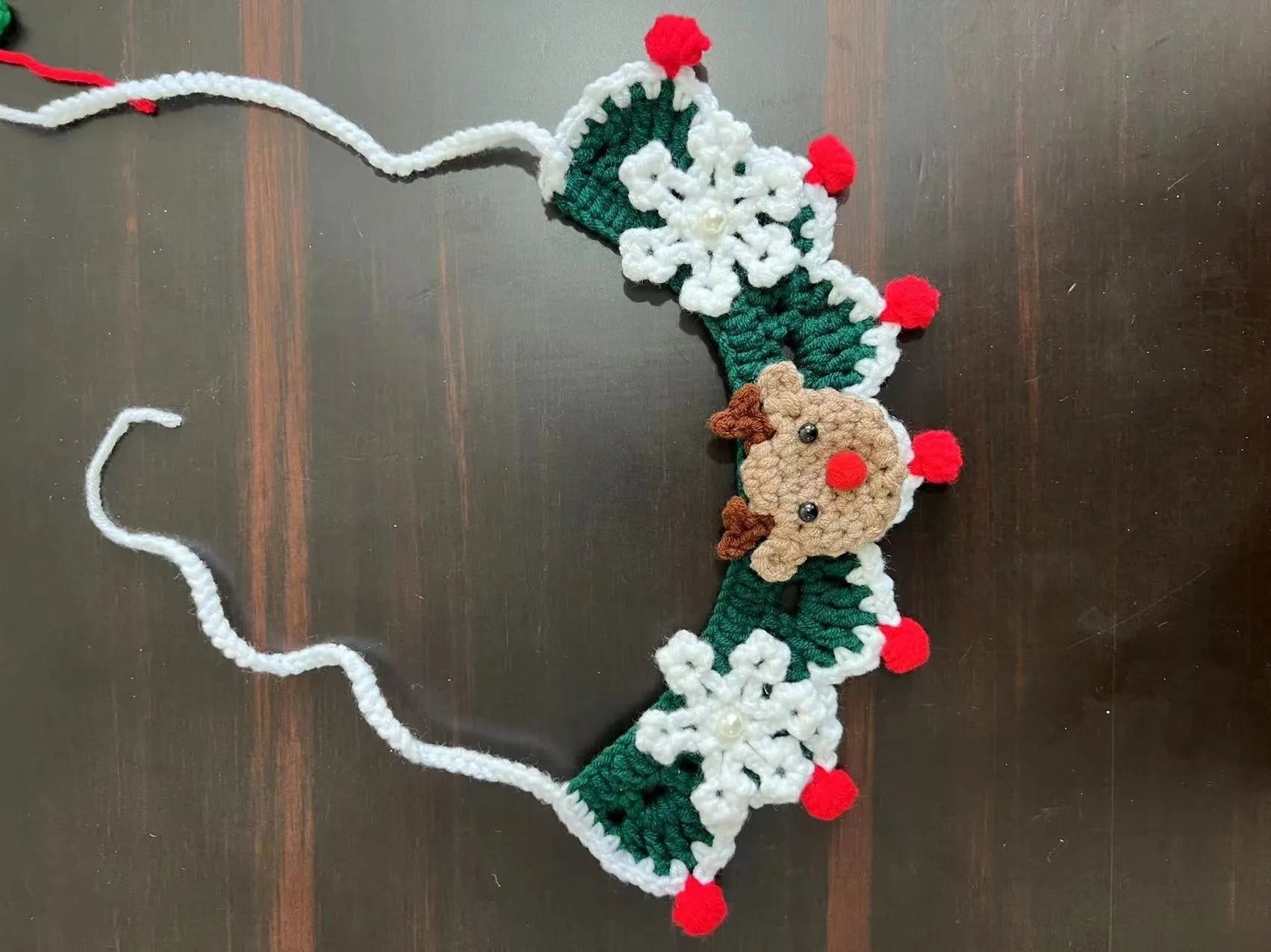 Knitted wool Christmas scarf for pets featuring festive patterns like striped Santa and elk, shown attached to a dog collar.