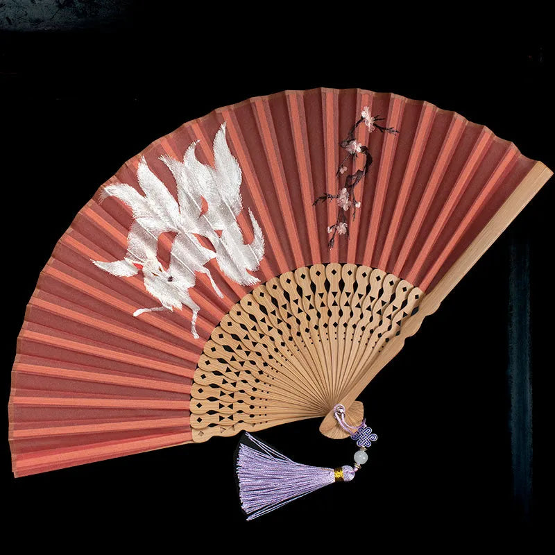 Bamboo frame silk embroidered folding fan showing intricate traditional patterns with folded and open positions
