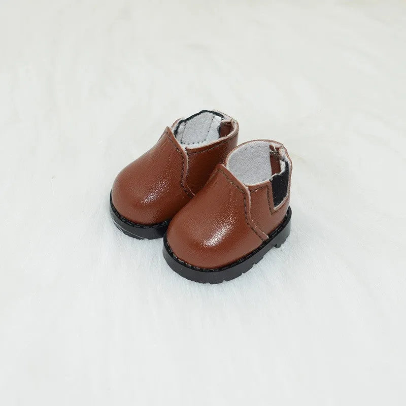 A pair of 17cm scale PU doll shoes in a selected colour and style, such as black leather shoes or brown boots.