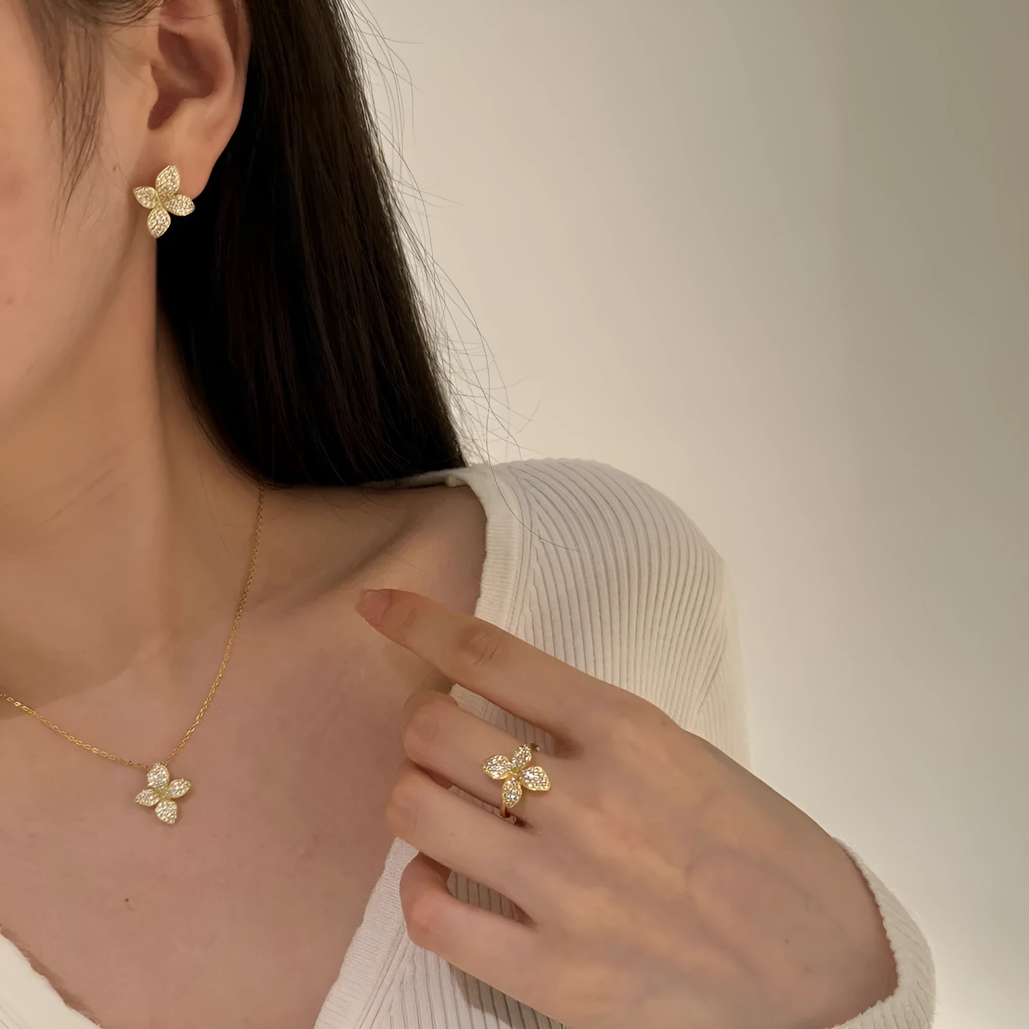 925 silver flower design open ring, necklace, and earring suite with white zircon inlay on a white background