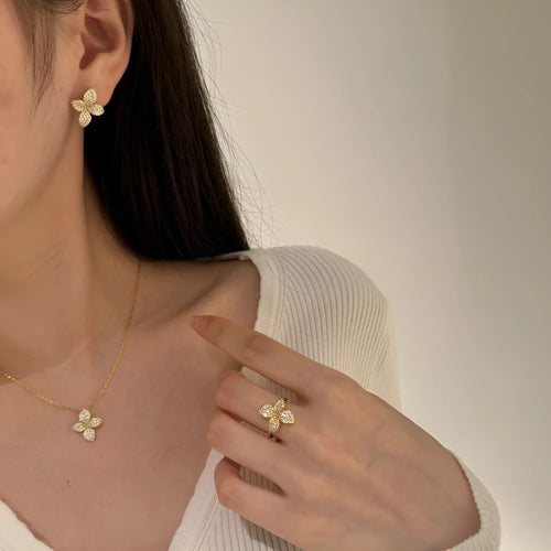 925 silver flower design open ring, necklace, and earring suite with white zircon inlay on a white background
