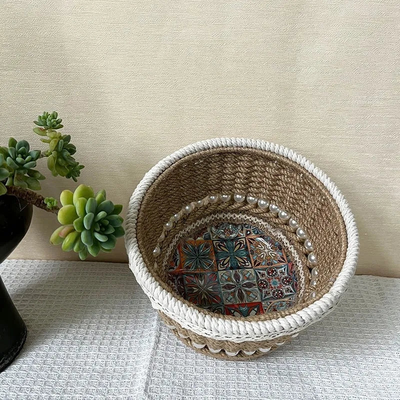 Hand woven rattan cylinder storage basket in solid green on a table, holding snacks and sundries