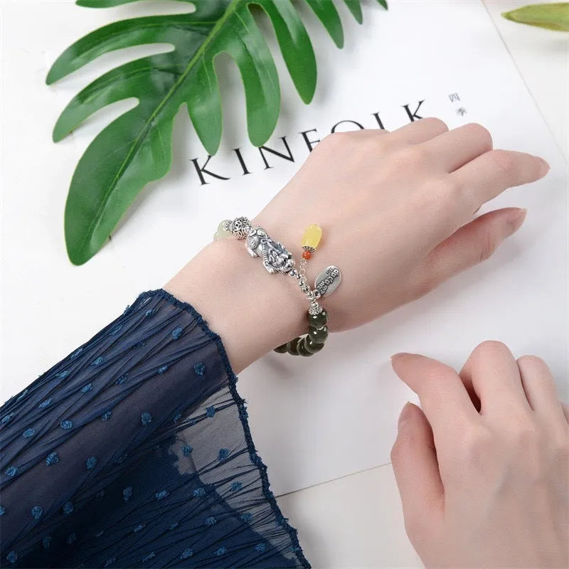 Retro women's pure silver bracelet with a Natural Hetian Jade stone and an 8mm coin charm.