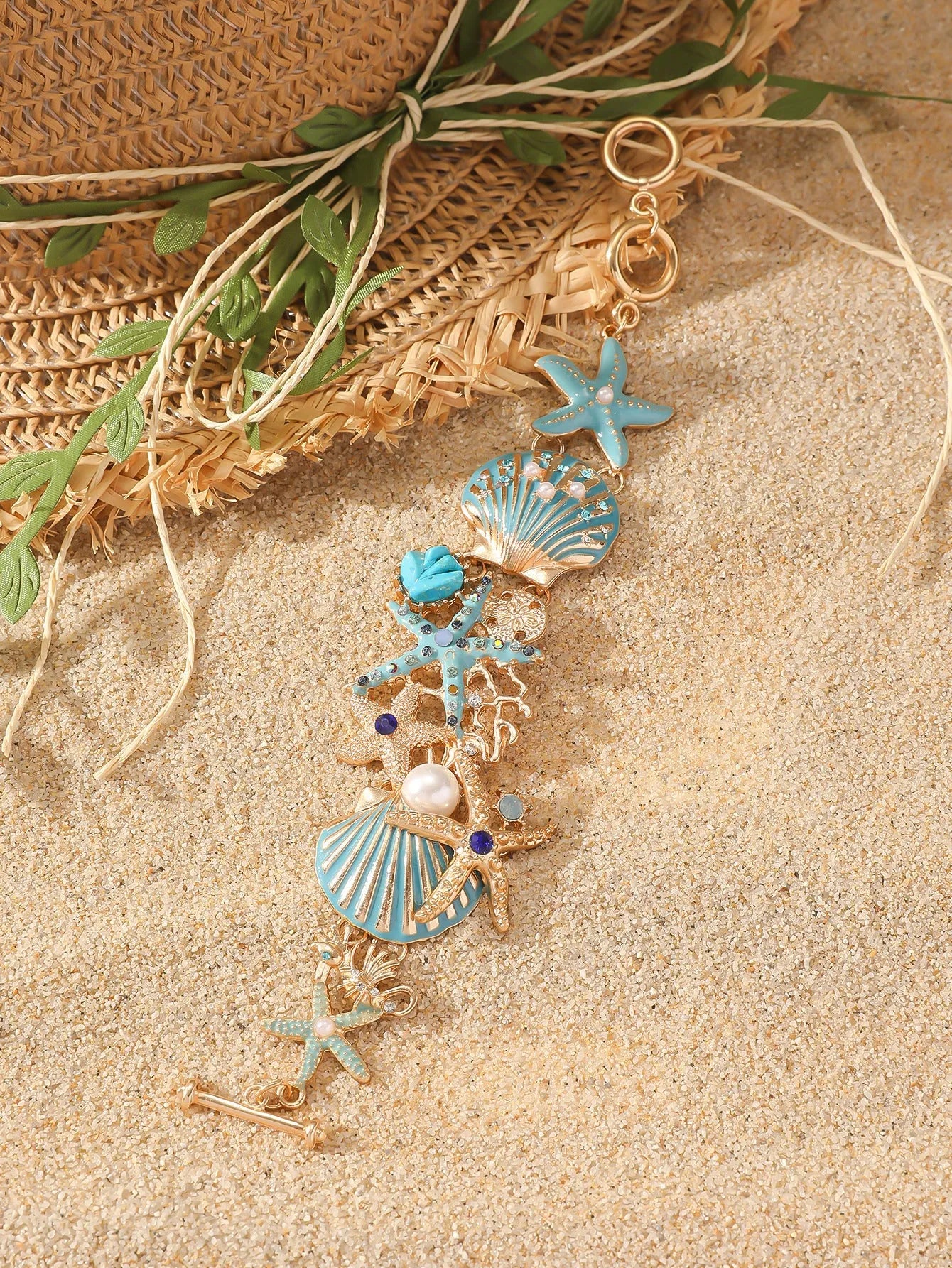 Alloy rhinestone bracelet with boat anchor and starfish design in turquoise, coral red, or coral blue.