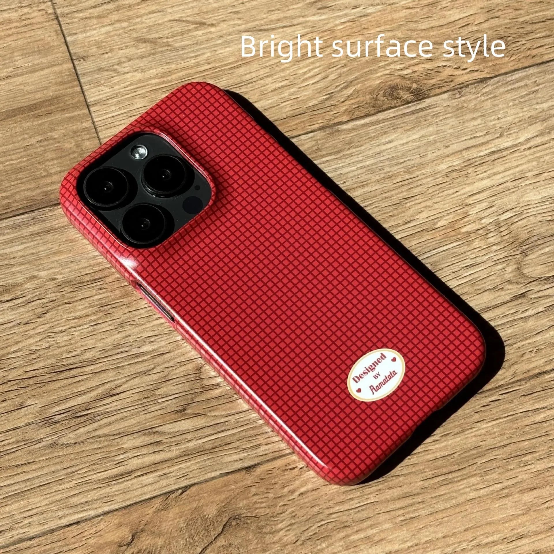 iPhone 15 Pro Max phone case with red and orange plaid design on glossy and frosted feilin shells.