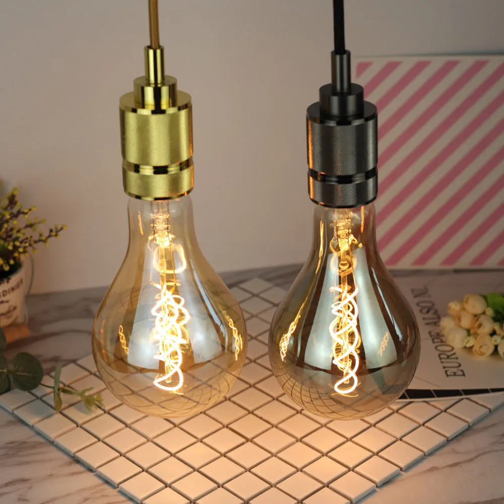 Double helix LED filament bulb in gold finish with spiral design visible through glass housing
