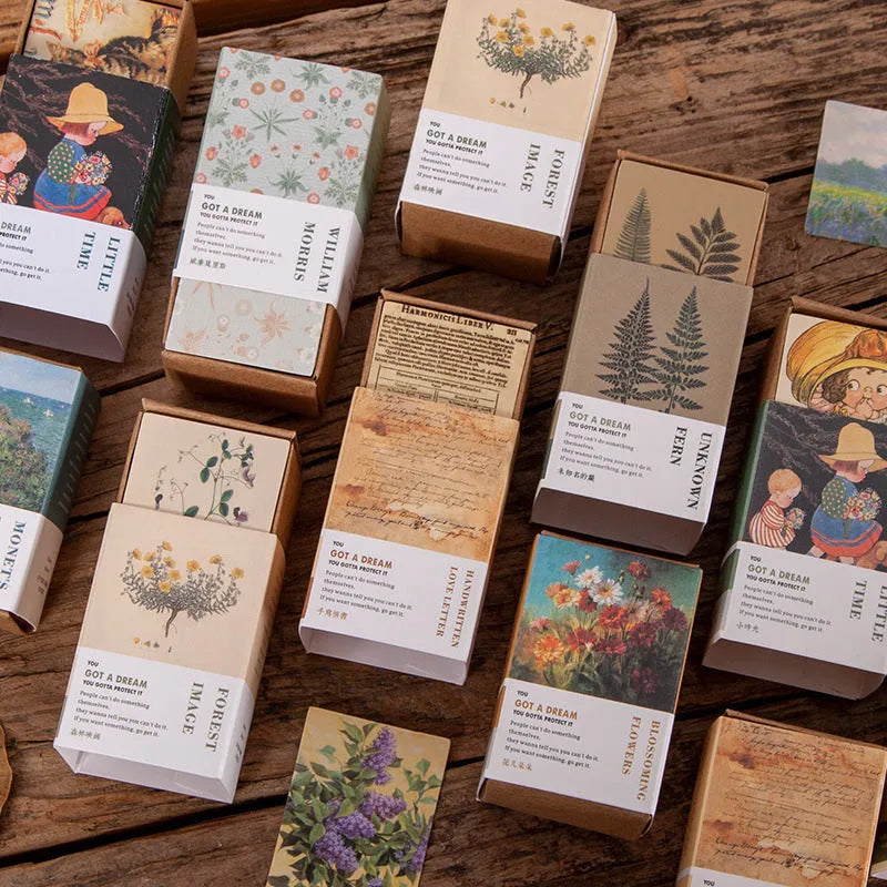 Pack of 100 small double-sided retro paper notes in various vintage colours on a wooden surface.