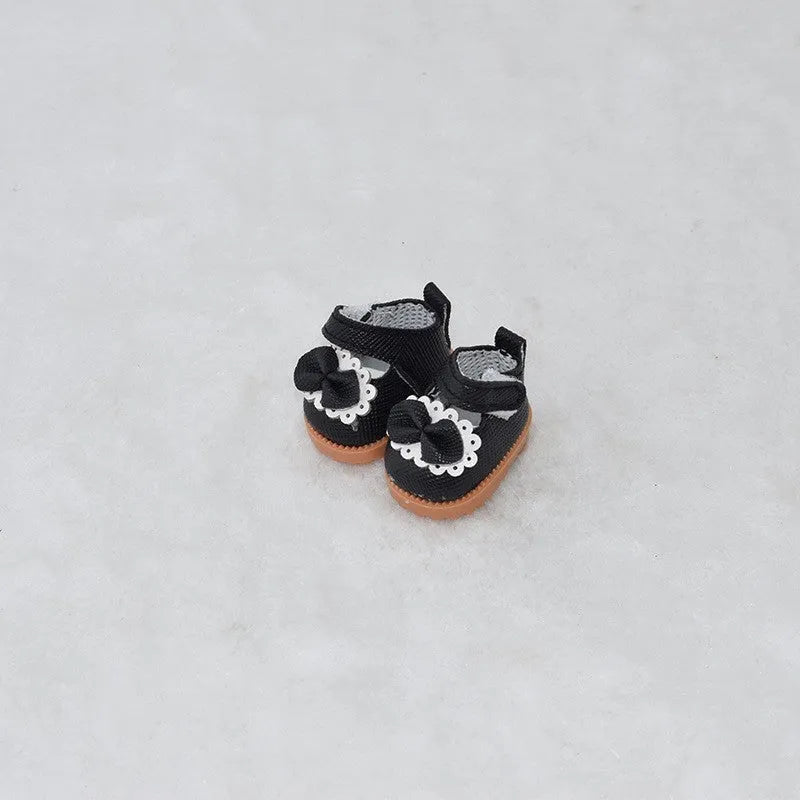 A pair of 17cm scale PU doll shoes in a selected colour and style, such as black leather shoes or brown boots.