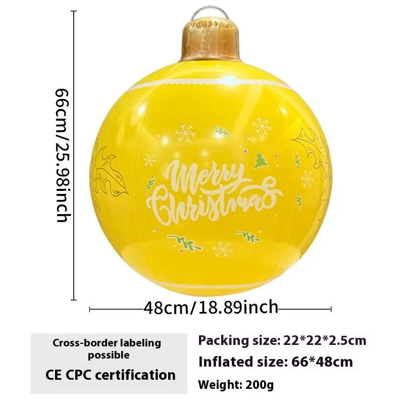 Large red inflatable Christmas ball with flashing lights displayed on a winter garden lawn.