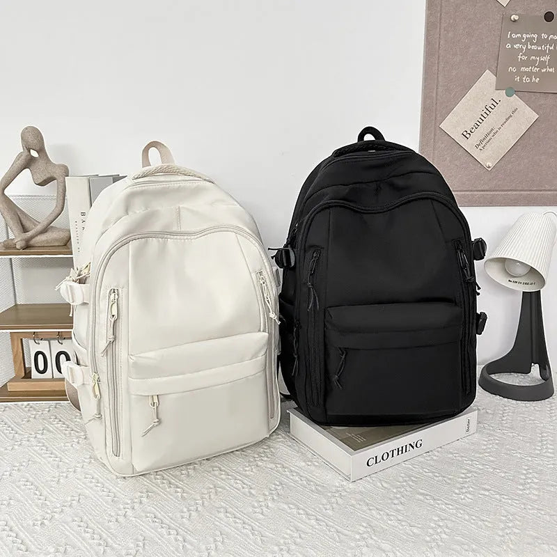 Women's large capacity solid colour schoolbag in black with curved shoulder strap and nylon material