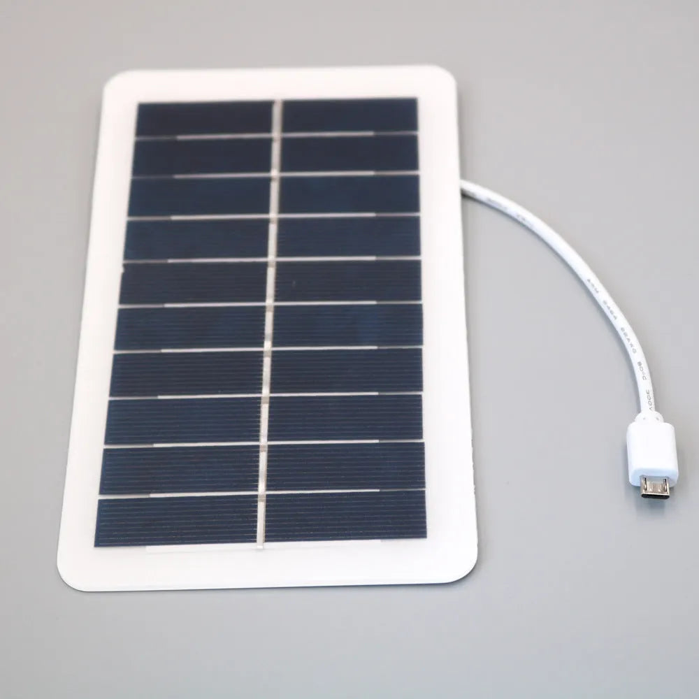 Black portable solar panel charger with USB output for mobile phones