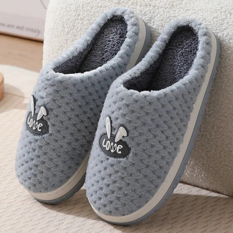 A pair of plush artificial fur house slippers with a baotou toe and a flat rubber sole, shown in a choice of colours.