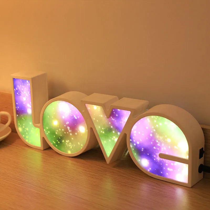 Rainbow style LED LOVE decorative table lamp with plastic shade on a table