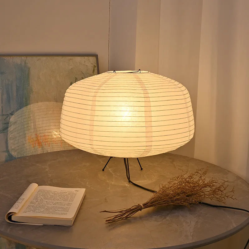 Japanese style xuan paper desk lamp on a wooden desk with soft warm light