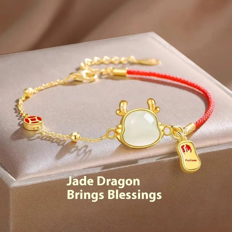 Silver-plated copper bracelet with a dragon zodiac pendant on a wrist.