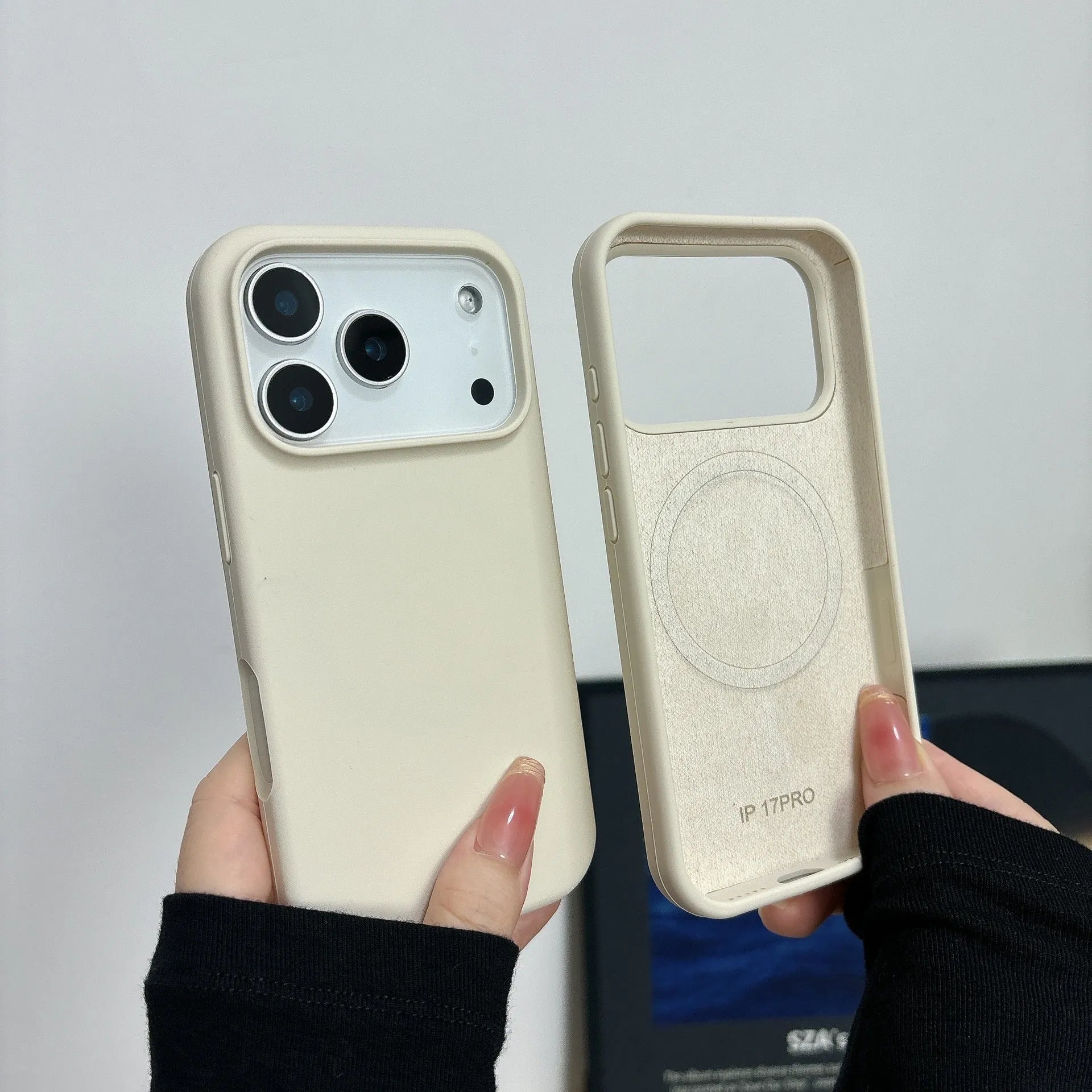 Liquid silicone magnetic iPhone case with Ai button in antique white colour on a table.